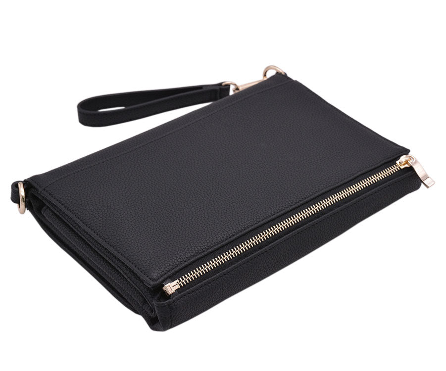 Black Indigo Nappy Changing Clutch laying on its side, showing the gold hardware on the detachable change mat. Wrist strap attached.